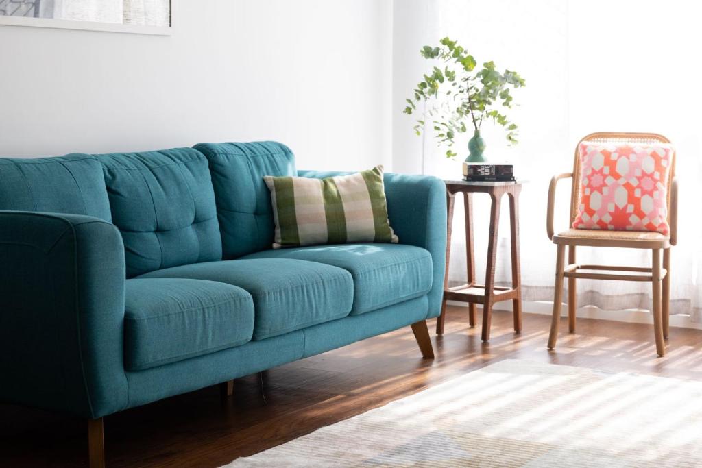 a blue couch in a living room with a chair at 1-45 Beech Street in Evans Head