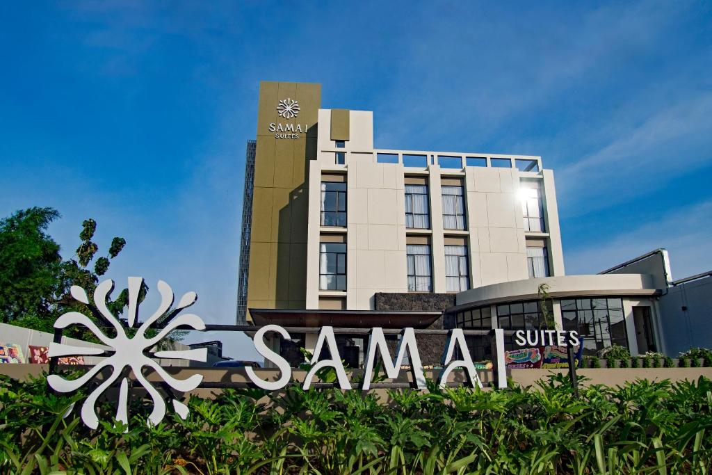 a santa suite hotel with a sign in front of it at Samai Suites in Bandar Lampung