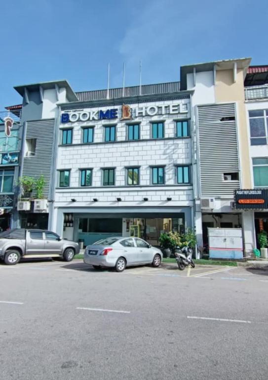 a hotel with two cars parked in front of it at BOOKME HOTEL in Johor Bahru
