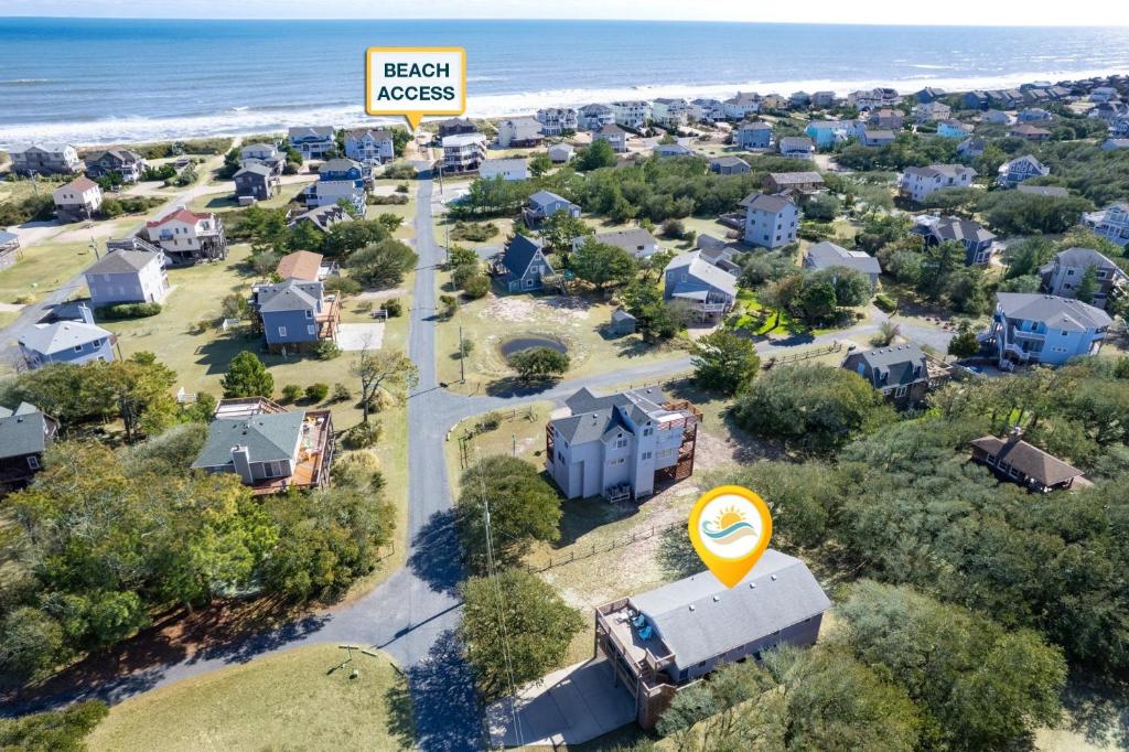 an aerial view of a suburb with a sign that reads beach kisses at 2010 - Just Ducky in Sanderling