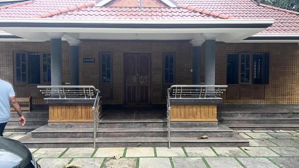 a man standing in front of a building at Zayas in Kundara