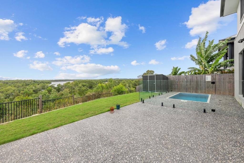 a backyard with a swimming pool and a fence at Spacious 4 Bed Home with Pool & Garden in Griffin