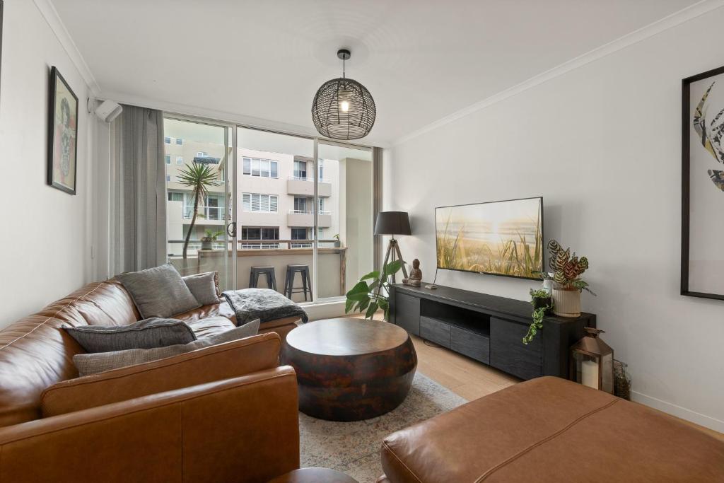 a living room with a couch and a table at Spacious 1 Bed Near Manly Beach in Sydney