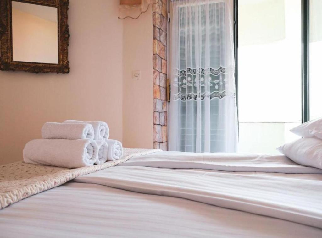 a bedroom with a bed with towels on it at Franov Butique Residence in Kali