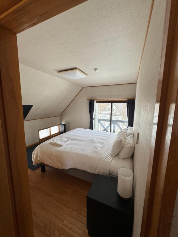 a bedroom with a large bed in a room at Kitakaze Chalet in Myoko