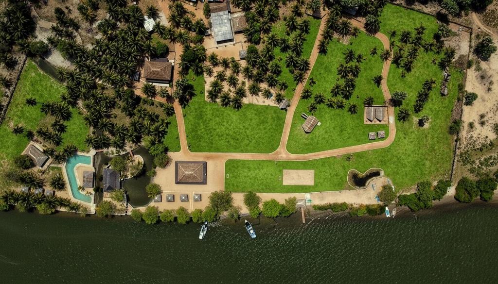 an aerial view of a house with a yard at The Cove Pasikuda - Eco Retreat in Pasikuda