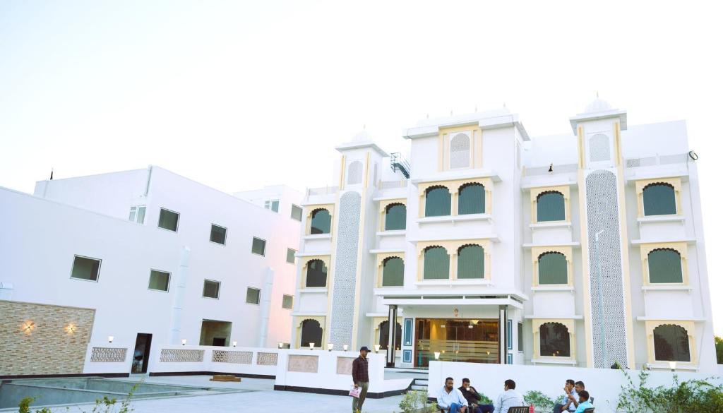 a group of people standing outside of a building at Sugan Hotel and Resort in Phalodi