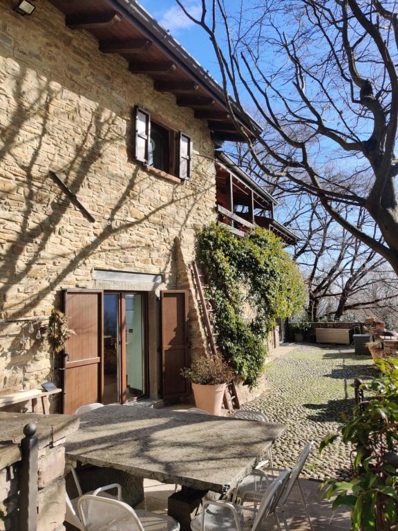 a stone house with a table in front of it at La cantina dell'artista in Palazzago