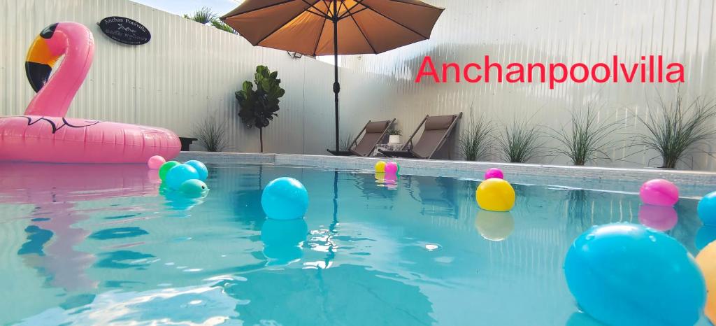a swimming pool with a bunch of inflatables in the water at AnChanPoolvilla อัญชัญ พลูวิลล่า in Pak Johng