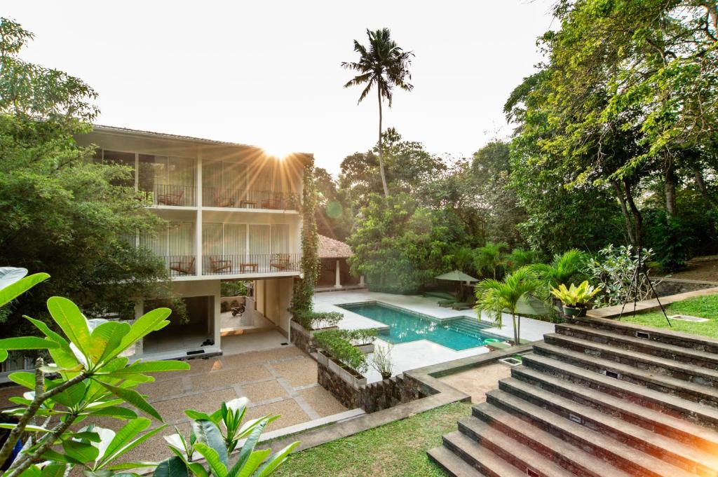 an exterior view of a house with a swimming pool at Tropical trails by wija house-unawatuna in Unawatuna
