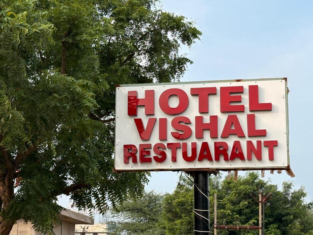a sign for a hotel vital restaurant on a pole at Hotel Vishal in Jaipur