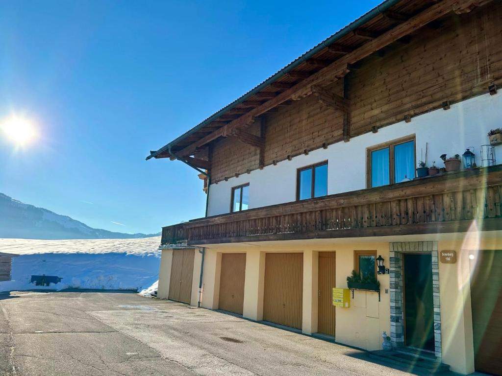 a building with a balcony on the side of it at Leogang apartment with mountain views in Leogang