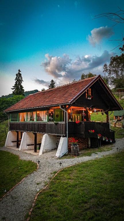 a large house with a gambrel roof in a field at La Răscoala in Petrila