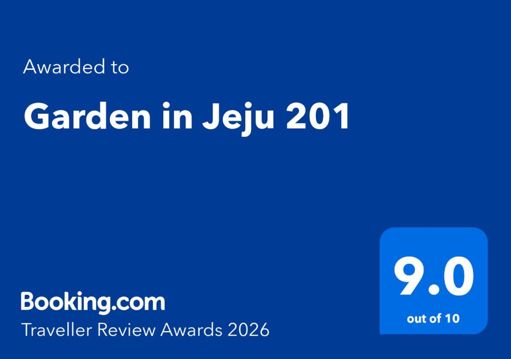 a blue sign with the words garden in jeku at Garden in Jeju 201 in Seogwipo