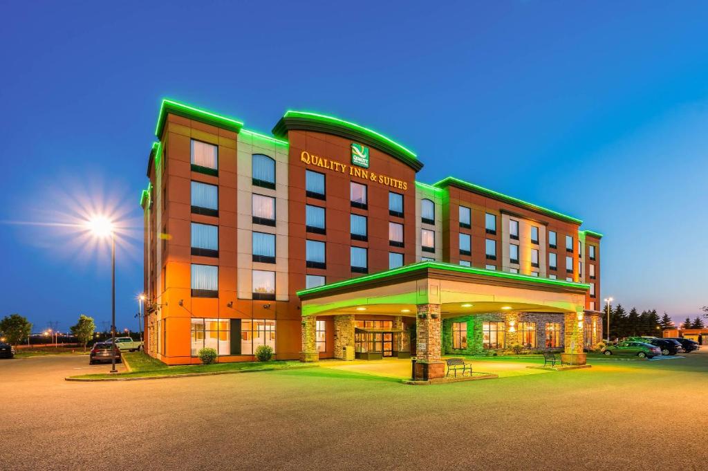 a large building with a parking lot in front of it at Quality Inn & Suites in Lévis