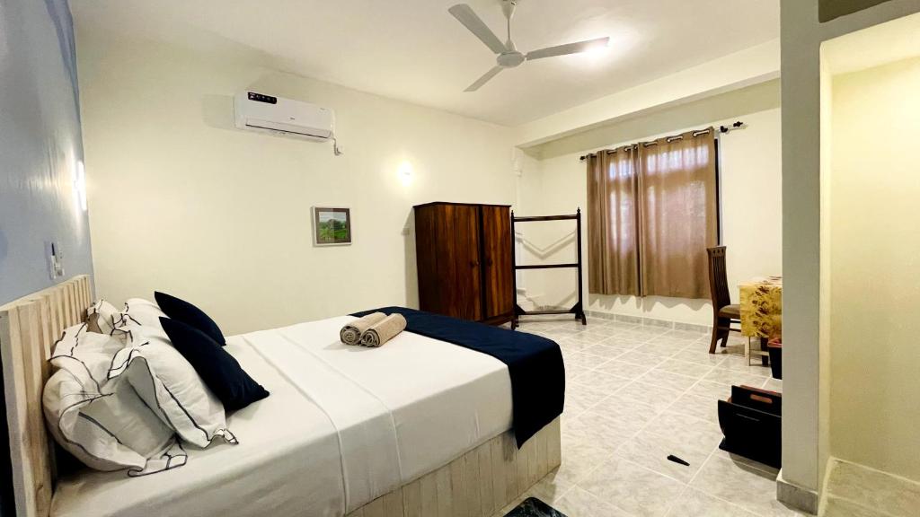 a bedroom with a large white bed in a room at Oliviana Resort in Bentota