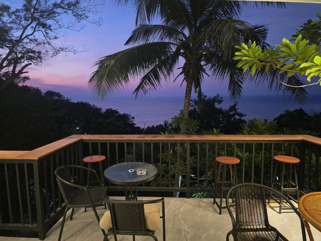 a patio with chairs and a table on a balcony at v26 Sunset Dreams - Seaview in Haad Yao in Haad Yao