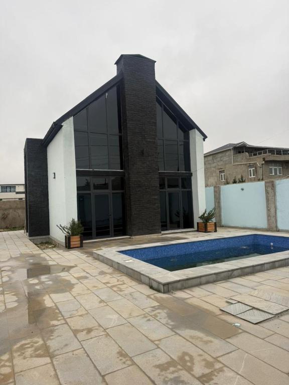 a building with a swimming pool in front of it at Garden house for rent2 in Baku