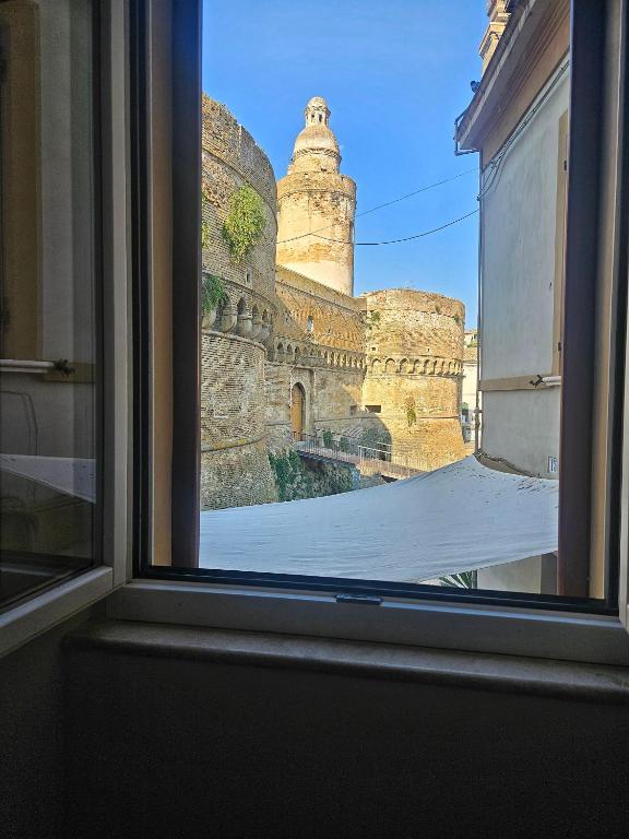a view of a castle from a window at La Guglia - Maison à Porter in Vasto