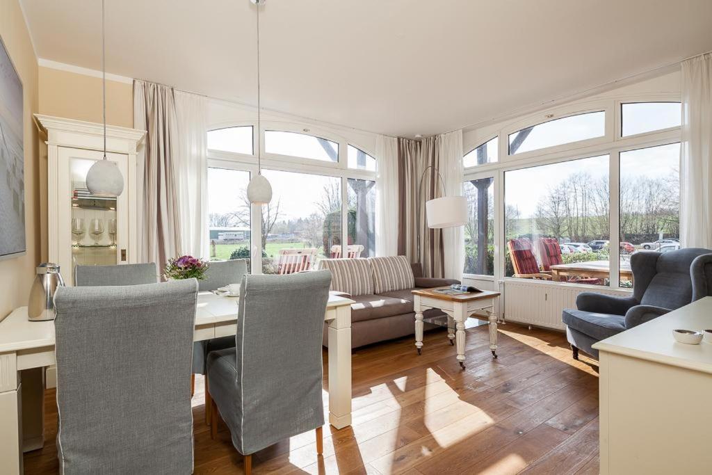 a dining room and living room with a table and chairs at Golfresidenz B 001 in Grömitz