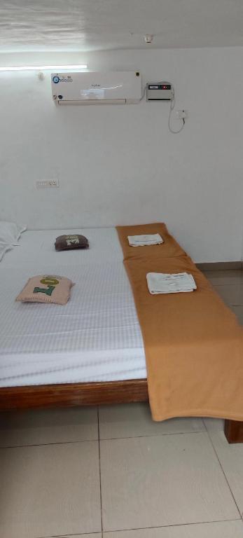a bed in a room with two towels on it at Beach Times Resort in Kottakupam