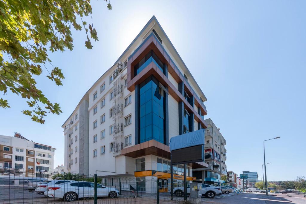 a building with cars parked in front of it at Premium Rezidans Otel in Antalya