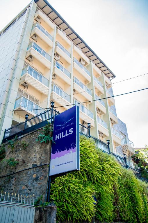 a sign in front of a tall building at Lavendish Hills Kandy in Kandy