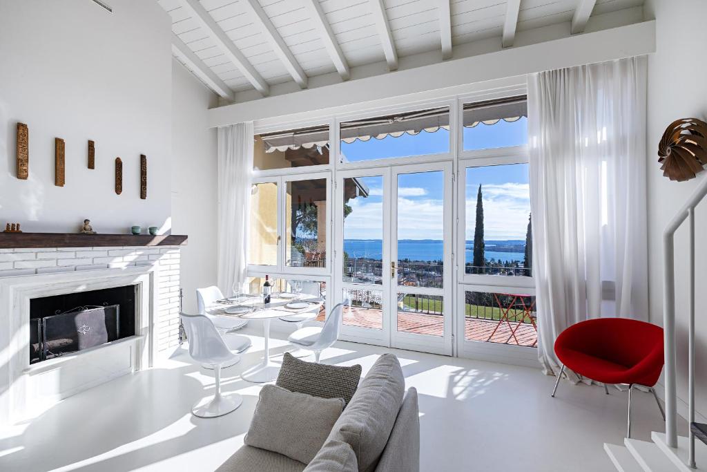 a living room with a couch and a fireplace at Bellavista by Whale Homes in Padenghe sul Garda