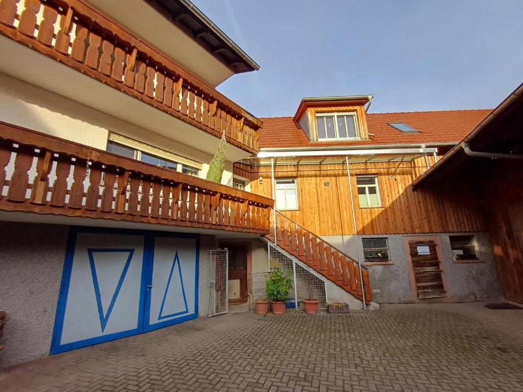 an apartment building with a staircase and a balcony at Ferienbauernhof Brandt in Klein-Bieberau