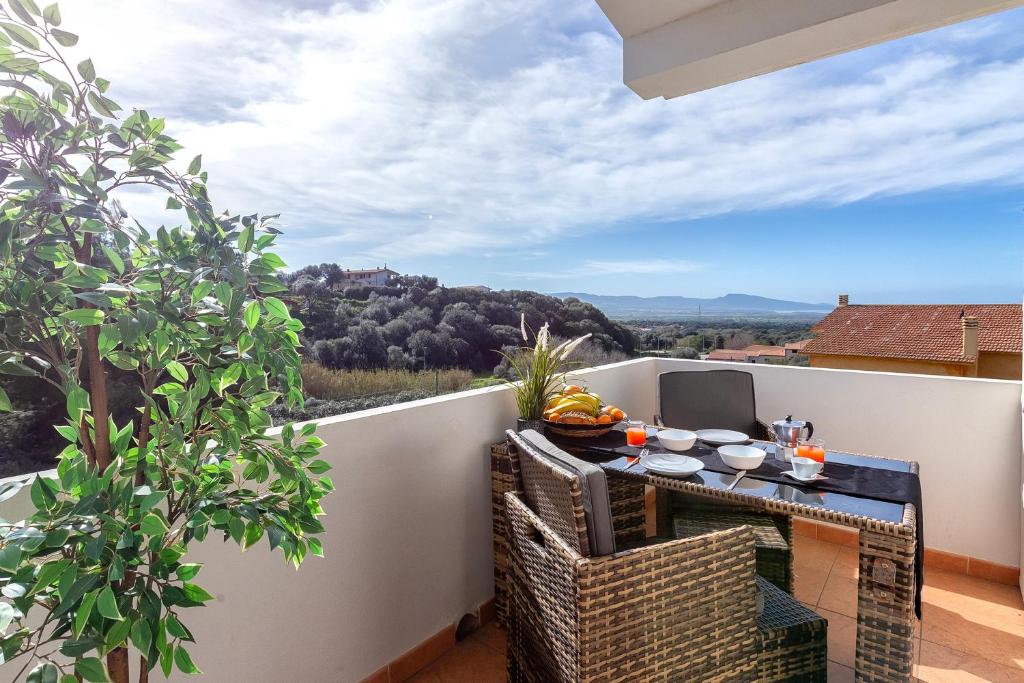 a balcony with a table and chairs with a view at Villa Agnese 2- Penthouse- Seaview in Badesi