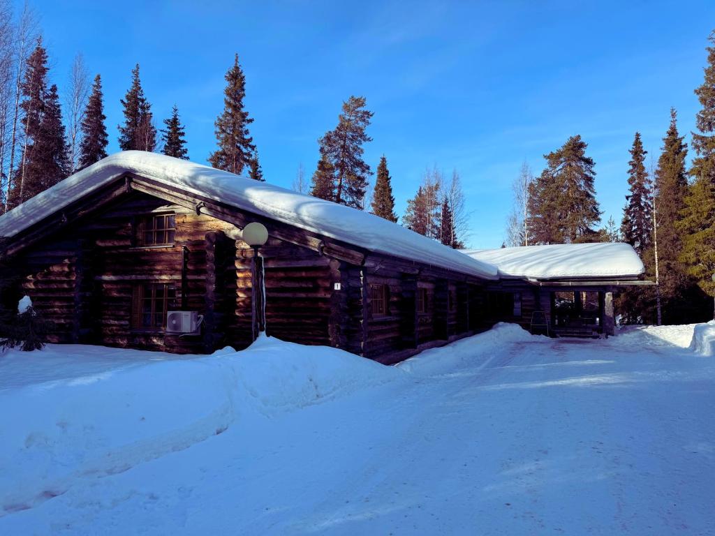a log cabin in the snow with snow at KunnonKolo in Luosto
