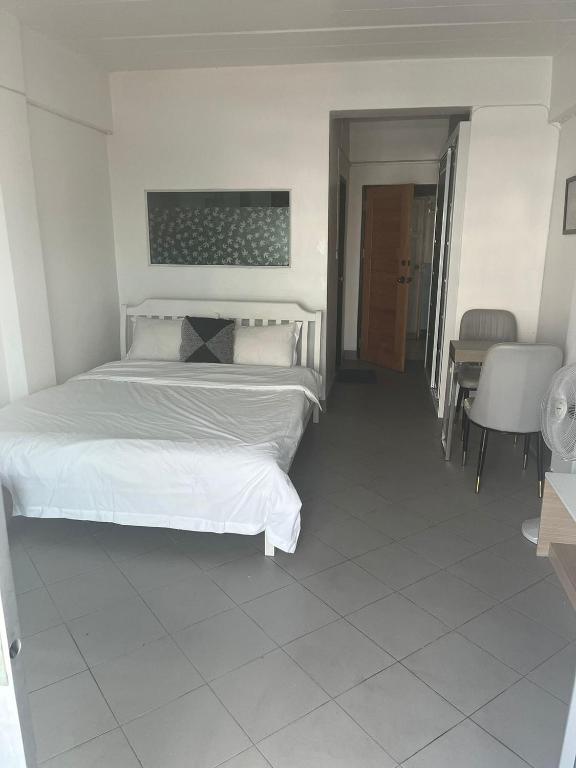 a bedroom with a bed and a table and chairs at Niruan apartment in Pattaya