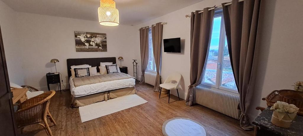 a bedroom with a bed and a large window at Le Clos du Bohon, 90m2 , calme dans l'Oise ,15 mn de Gisors et son chateau in Labosse