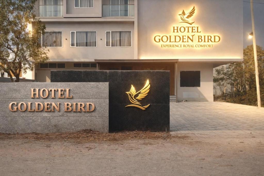 a hotel golden bird sign in front of a building at Hotel Golden Bird in Dabok