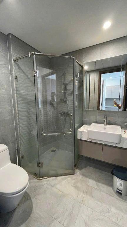 a bathroom with a shower and a toilet and a sink at Homestay đẹp và rẻ r105 in Gia Lâm Pho