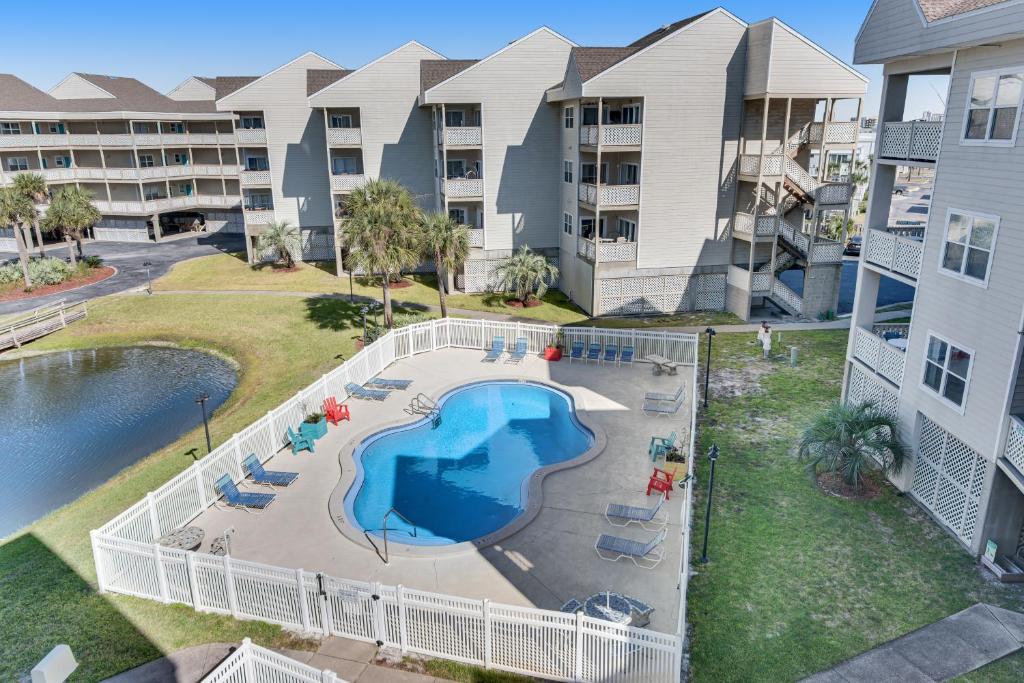 an aerial view of an apartment complex with a swimming pool at Condo with partial bay view onsite fishing dock beach access & shared pool in Pensacola Beach