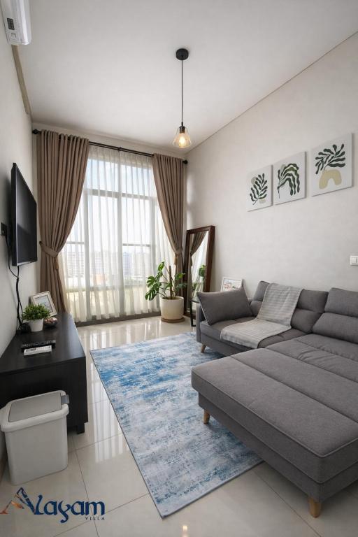 a living room with a couch and a tv at Alayam Villa Padalarang near whoosh, wahoo waterworld & ikea in Padalarang