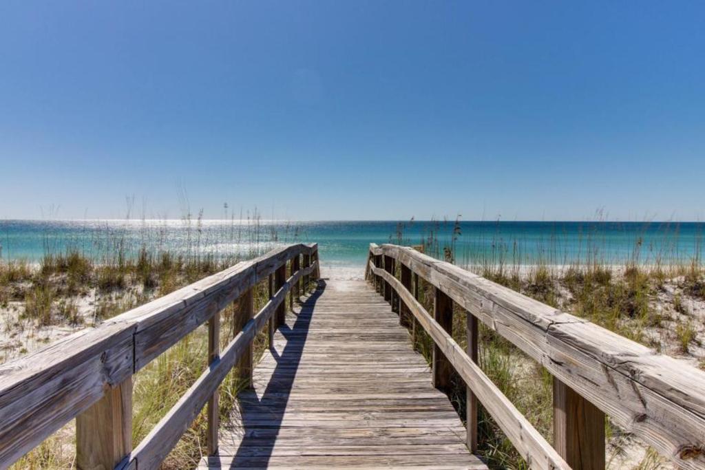 a boardwalk to the beach with the ocean in the background at Cozy top-floor beachfront condo with pool pool spa & beach access in Perdido Key