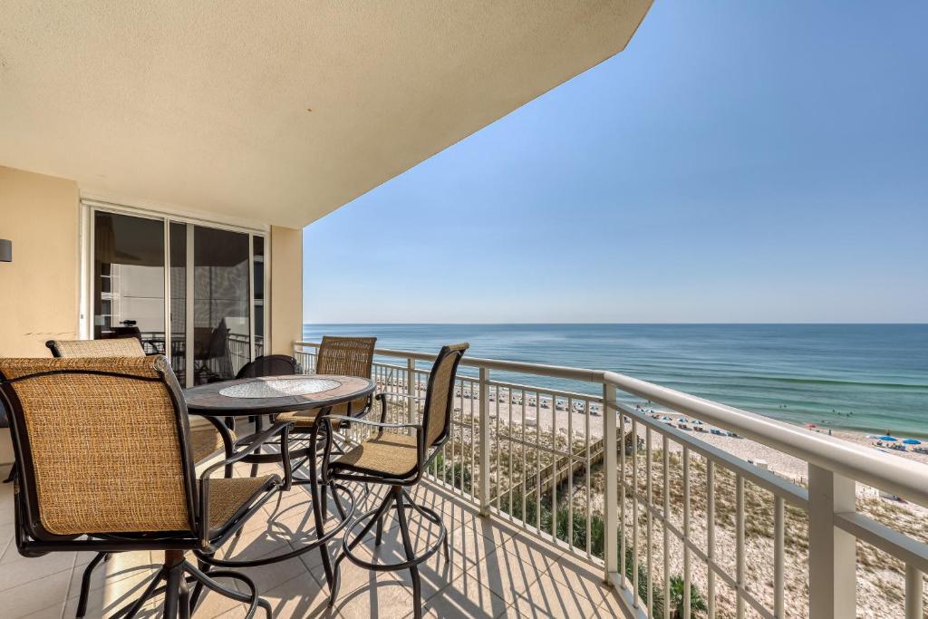 a balcony with a table and chairs and the ocean at Gorgeous cozy beachfront condo with pool pool spa & beach access in Perdido Key