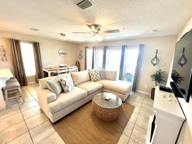 a living room with a couch and a table at 3rd Floor Spacious Condo Close To Entertainment Shared pool Wifi in Navarre