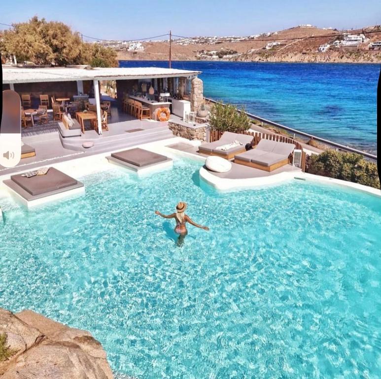 a person swimming in a swimming pool in a house at The Dimora by Mazera in Ornos