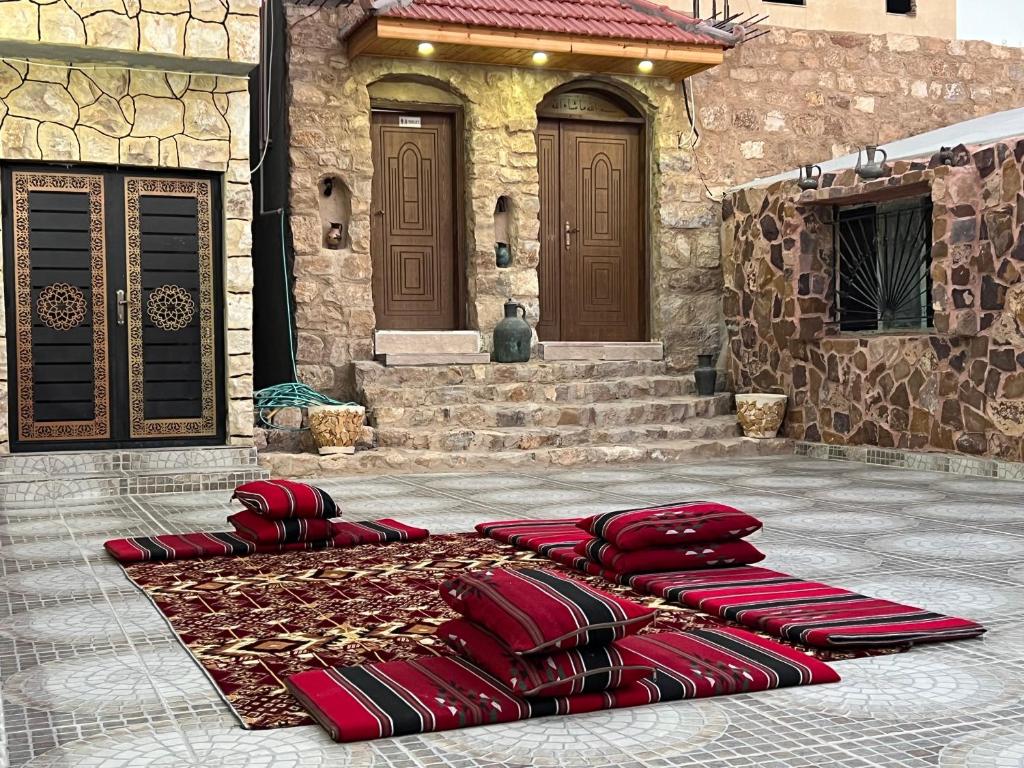 a group of red chairs sitting in front of a building at Eman house in Wadi Musa
