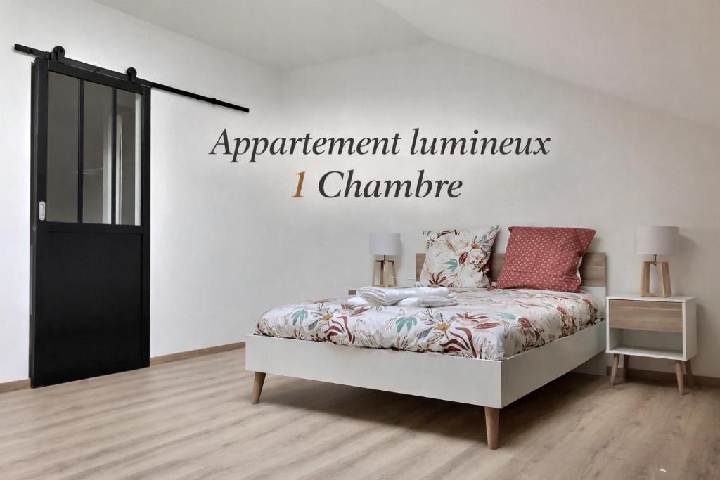 a bedroom with a bed with a sign on the wall at Appartement spacieux et lumineux proche gare in Ambérieu-en-Bugey