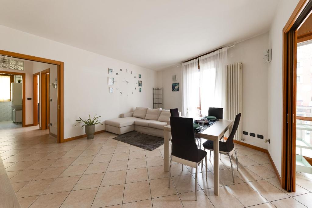 a living room with a table and a couch at Residenza Quadrifoglio in Cesena