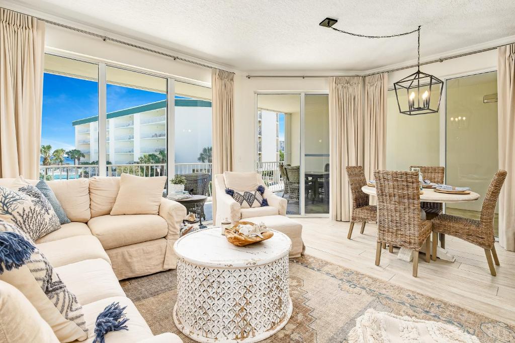 a living room with a couch and a table at Chic first-floor condo with Gulf & pool view & pickleball - steps to beach in Santa Rosa Beach