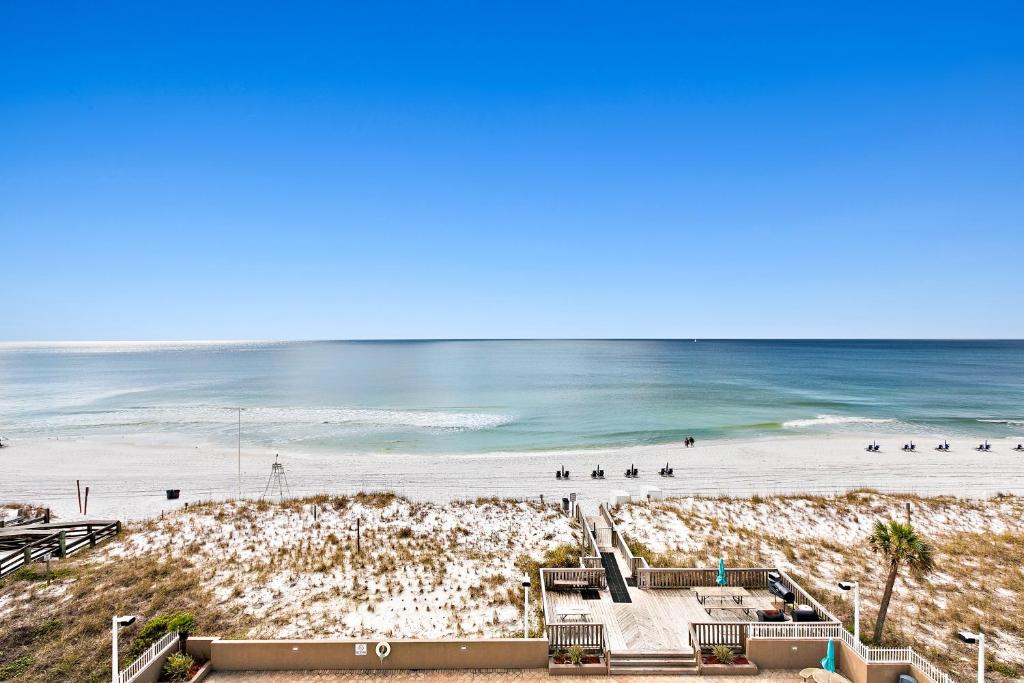 a view of a beach with people in the water at Spacious home with balconies shared pool and beach access in Fort Walton Beach