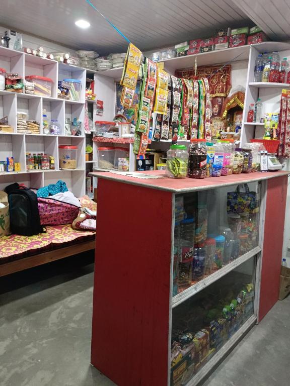 a store with a red counter in a room at Pines pool homestay in Darjeeling