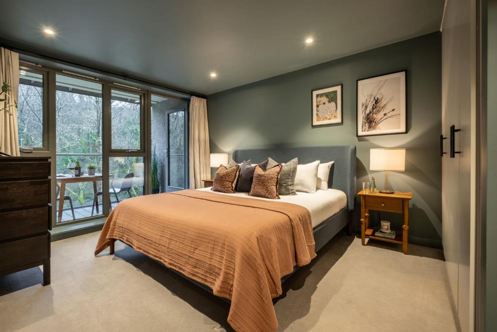 a bedroom with a bed and a window at 34 Ironworks in Backbarrow