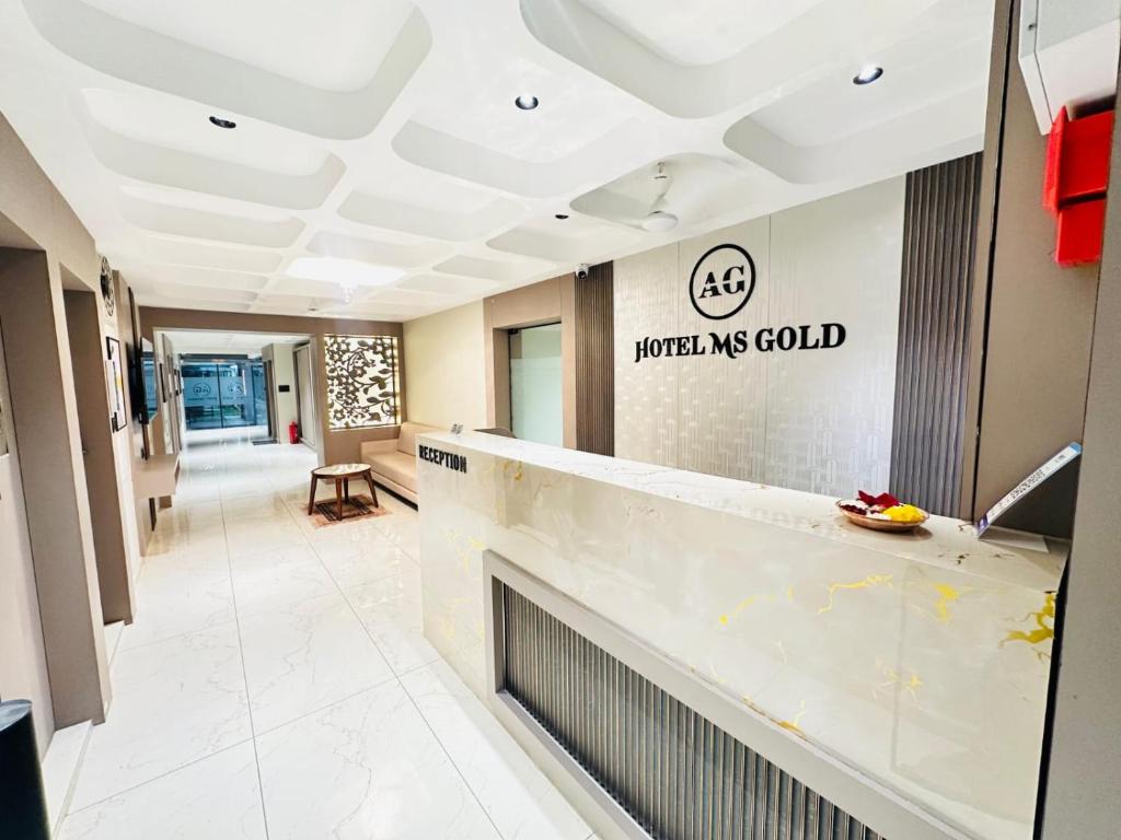 a lobby of a hospital with a reception counter at Hotel M S Gold Ganadhinagar in Gandhinagar