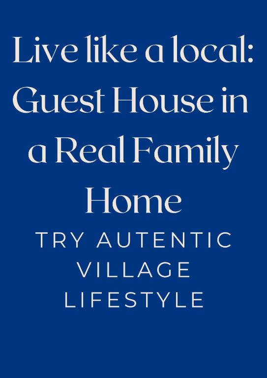 a blue sign that reads live like a local guest house in a real family home at Kowlessur Residence in Surinam